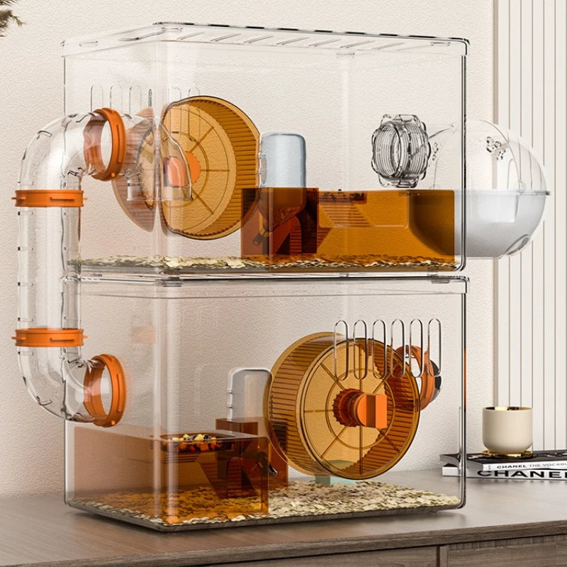 Clear hamster cage with wooden wheels and platforms on a wooden surface.